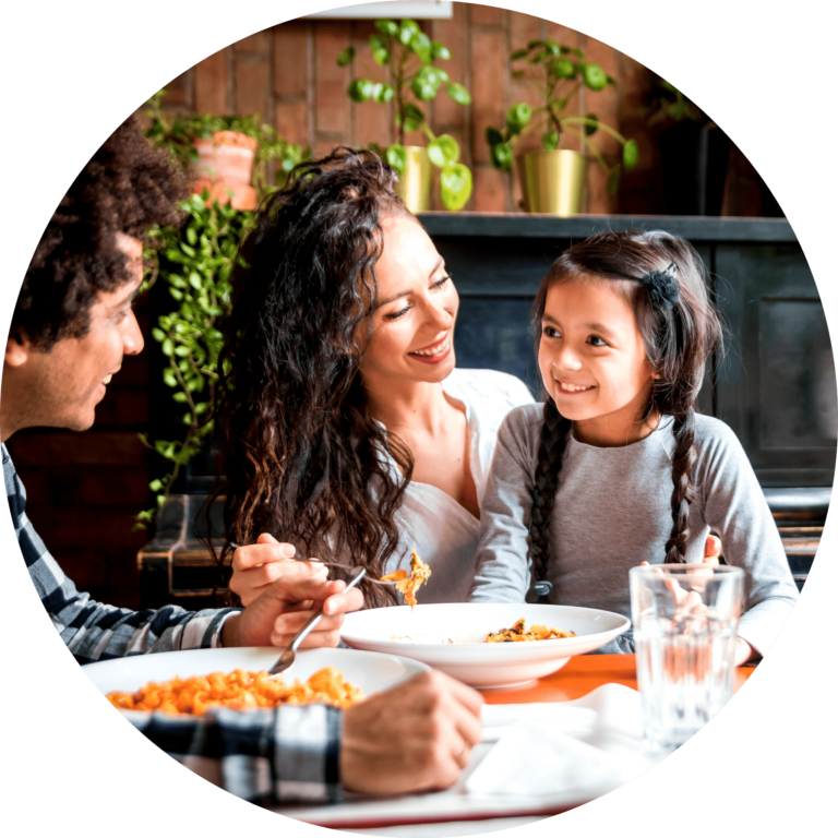 family of three sitting around dinner table