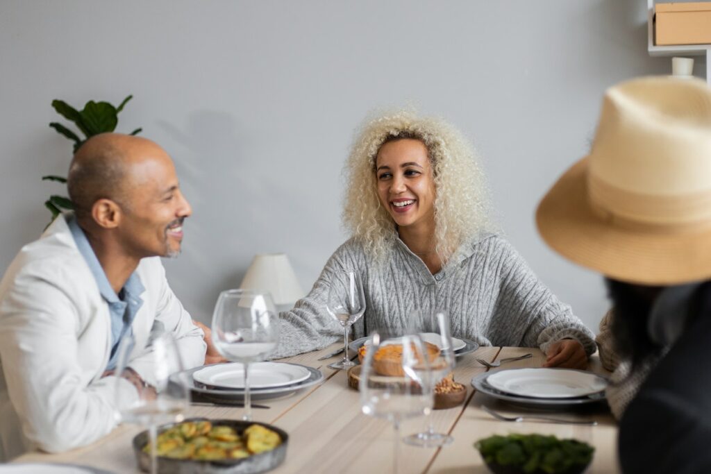 Smiling group at a table eating dinner