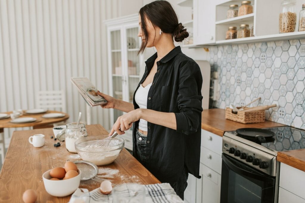 Woman in long black sleeves holding a recipe