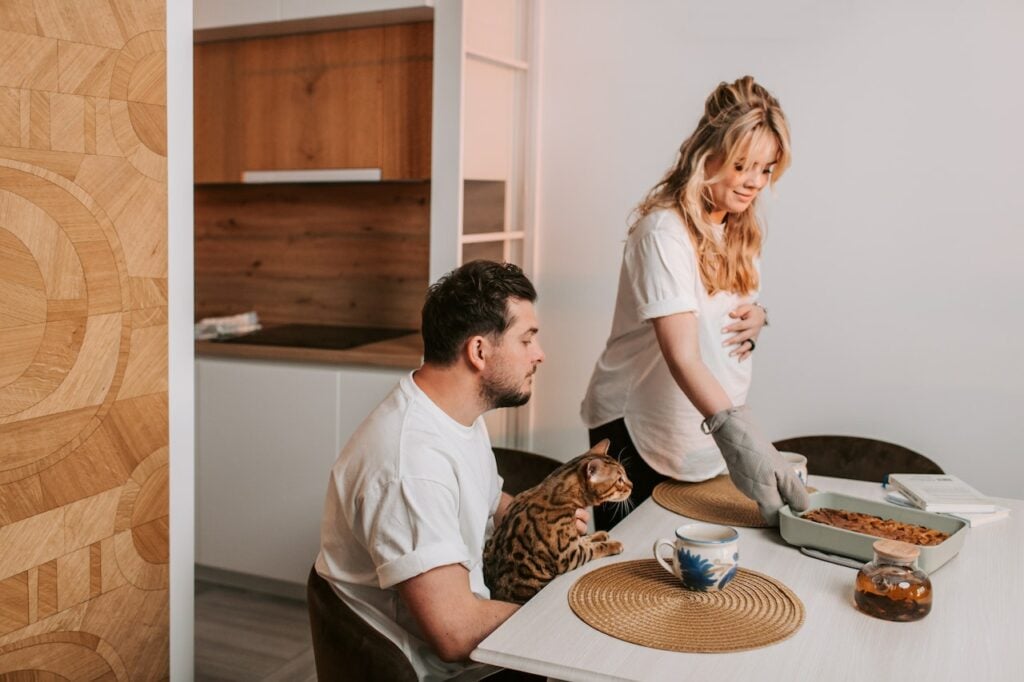 pregnant women serving dinner to partner on dinner table