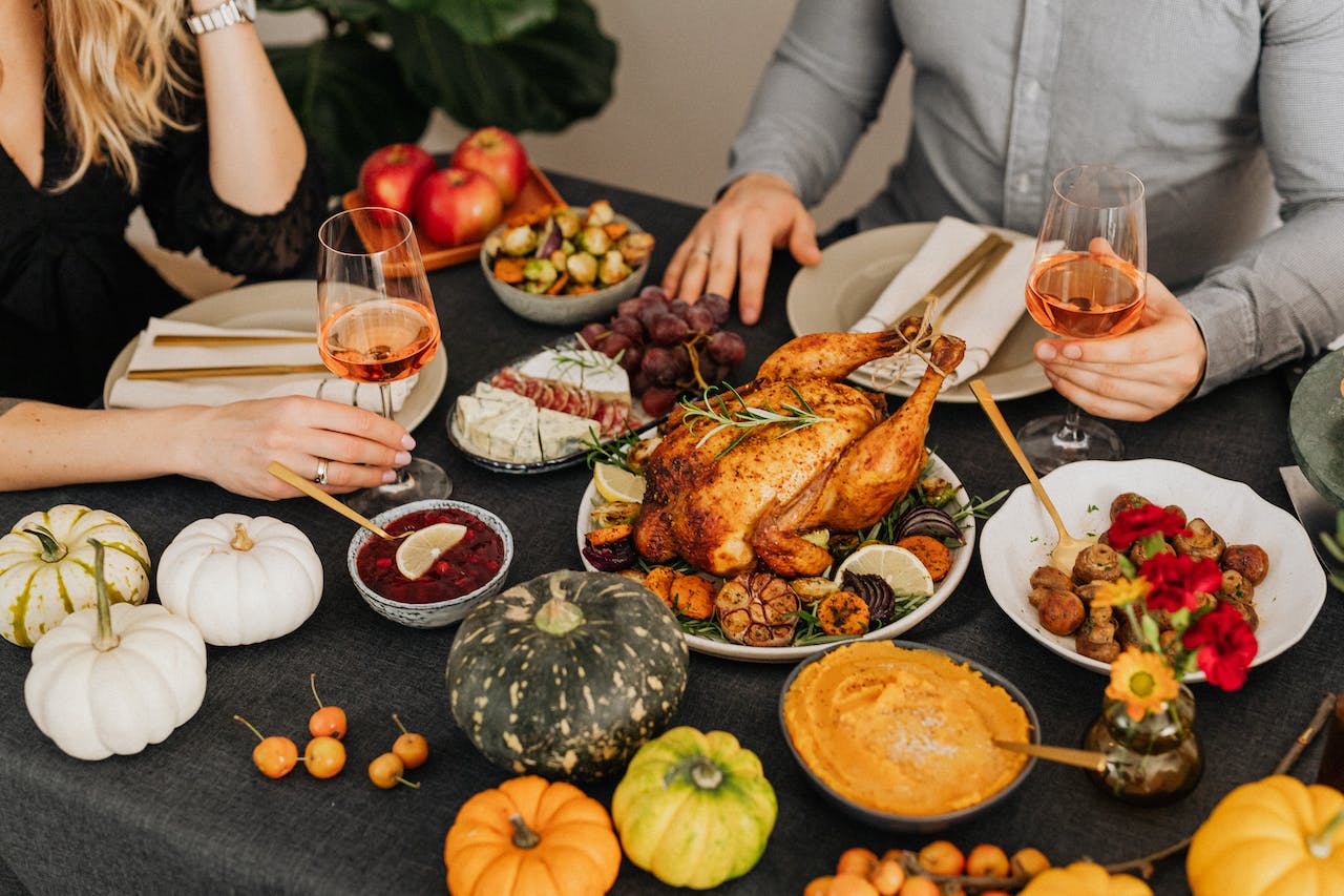 Couple have thanksgiving dinner with a holiday meal and wine